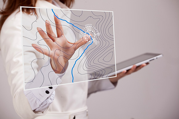 Geographic information systems concept, woman scientist working with futuristic interface in GIS software on a transparent screen.