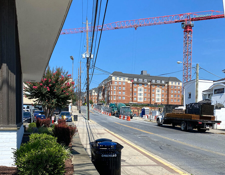 Construction crane near building along street. 