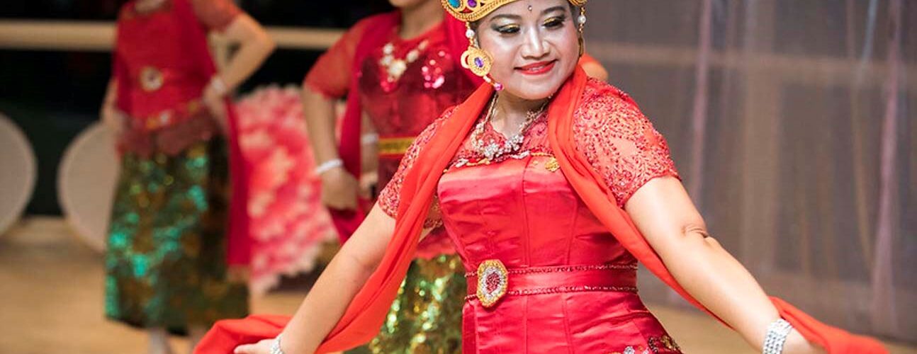 women in South east asian maybe thai traditional dress performing on stage