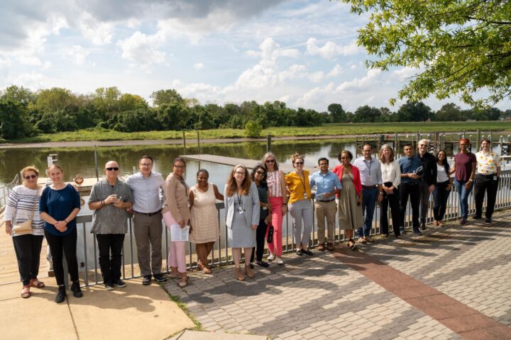 Staff poses in front of river