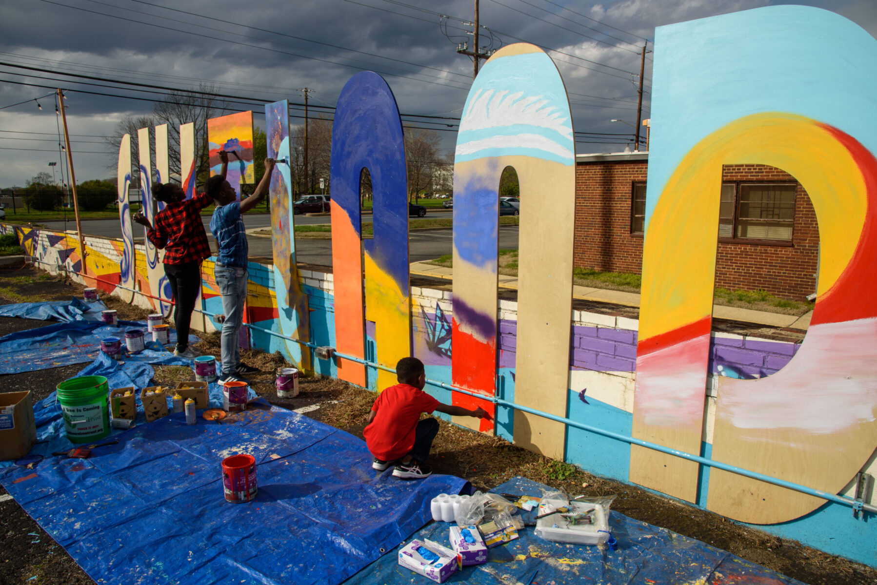 Suitland mural being painted on city name cutouts