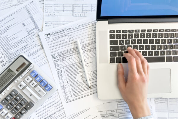 Tax paperwork with computer.