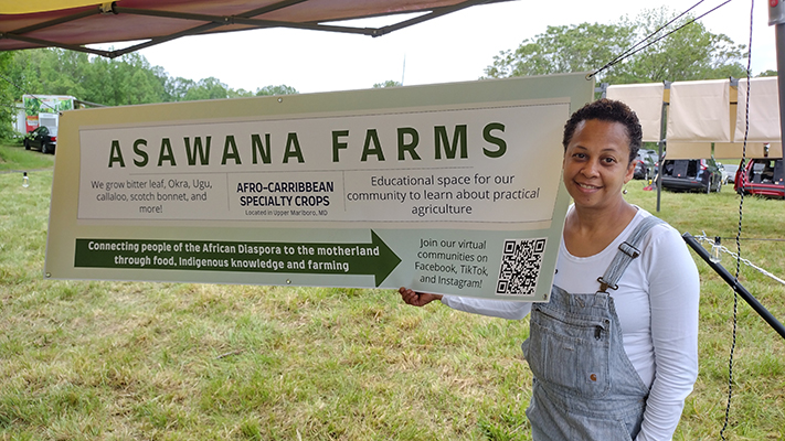 Asawana Farms sign and host at a farmers market.
