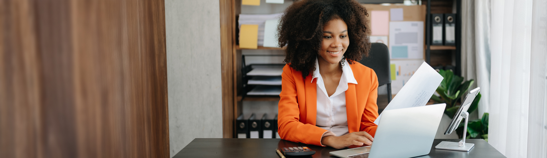 Business woman at desk with computer. Photo by nuttapong punna at istockphoto.com.
