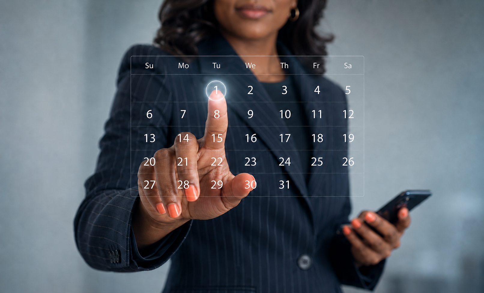 African American professional in a navy pinstriped suit selects a date on a transparent digital calendar while holding a smartphone.
