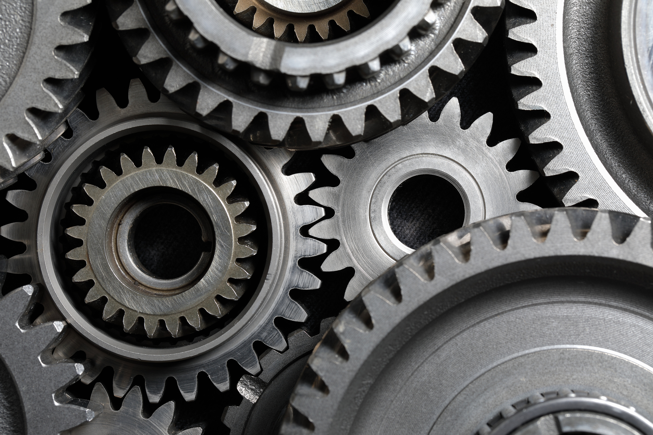 Metal cogs and machine gears working together.