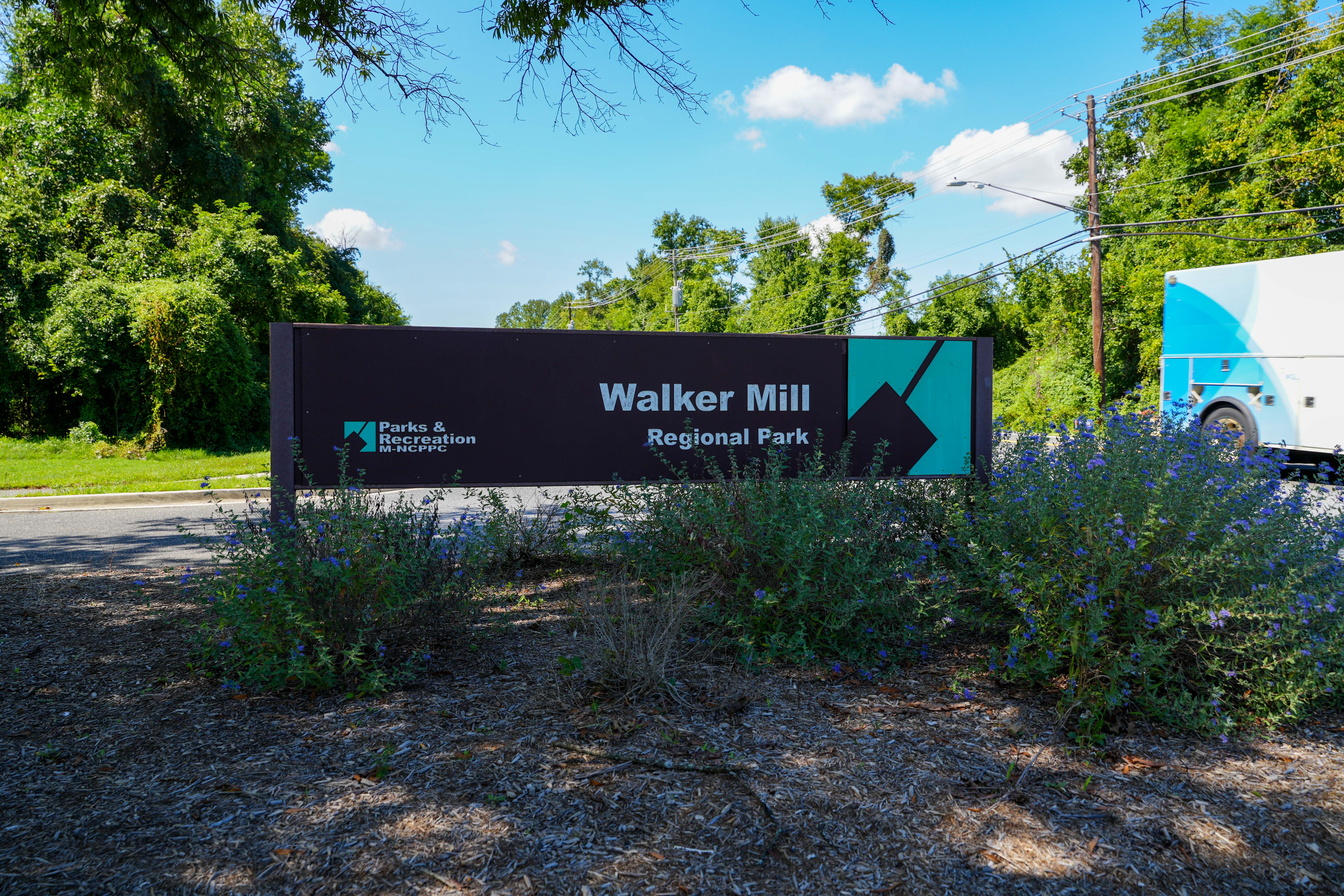 A green space surrounding the Walker Mill Regional Park sign.